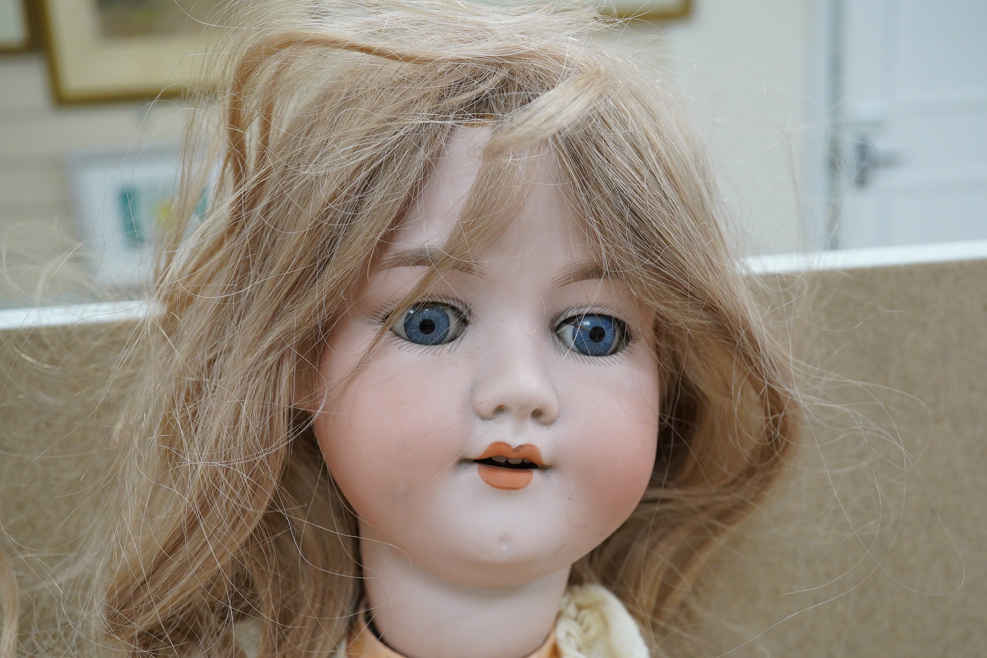 A large Armand Marseille doll with a silk dress, 66cm. Condition - fair to good, silk dress rotted.